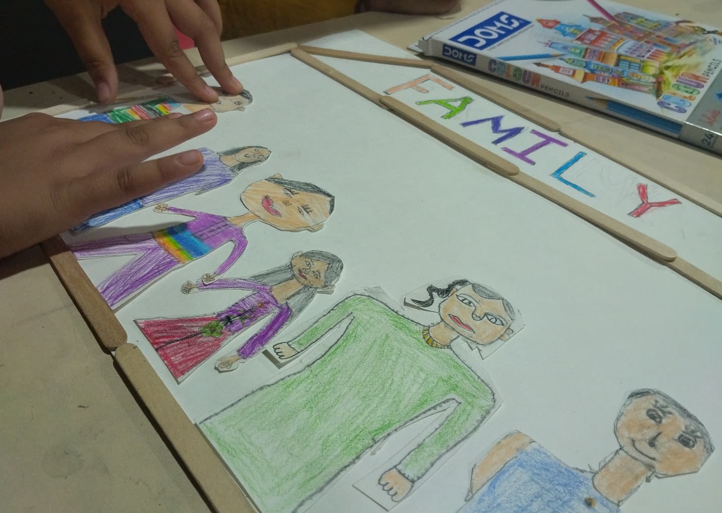 A child's colourful hand-drawn artwork of their family